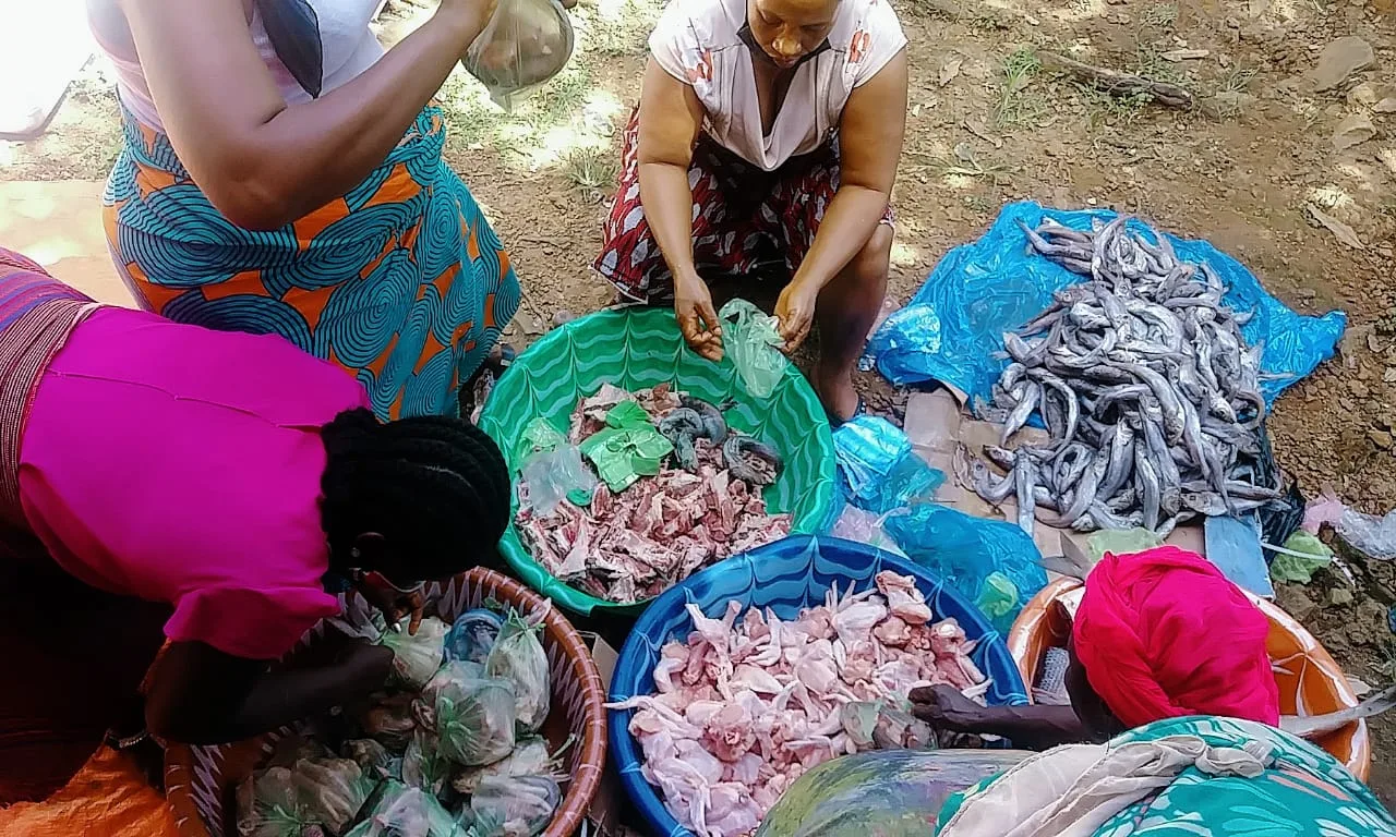 Community members preparing food together during a distribution outreach